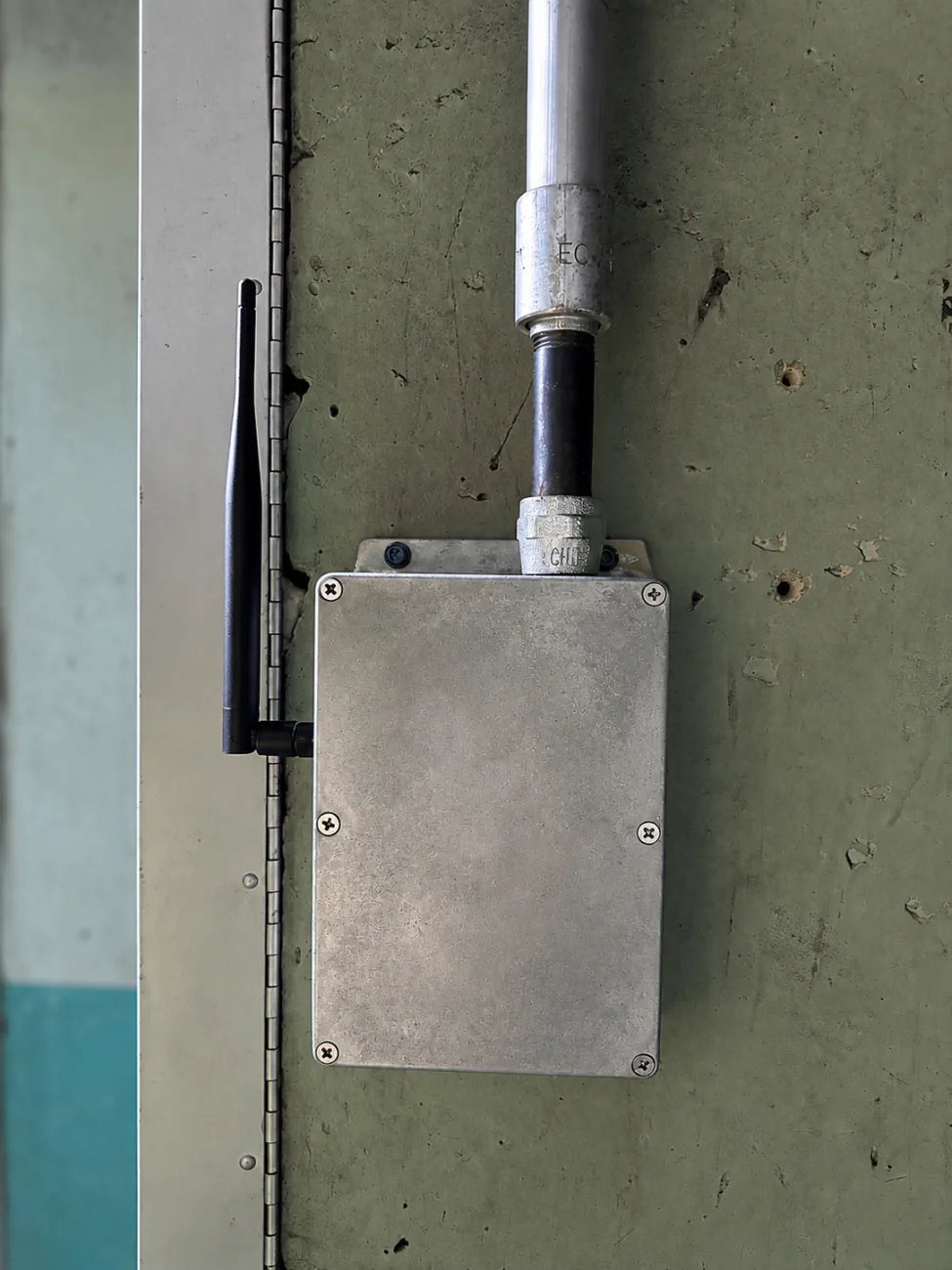 Silver Industrial Ethernet Panel with an external antenna mounted on a plant enclosure